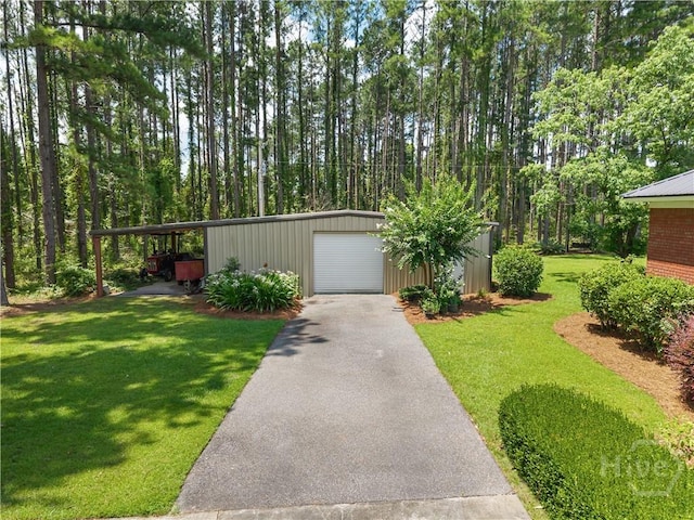 2055 Blankenbaker Rd, Statesboro, GA 30458 - view of grassy yard featuring an outdoor structure, asphalt driveway, and a garage
