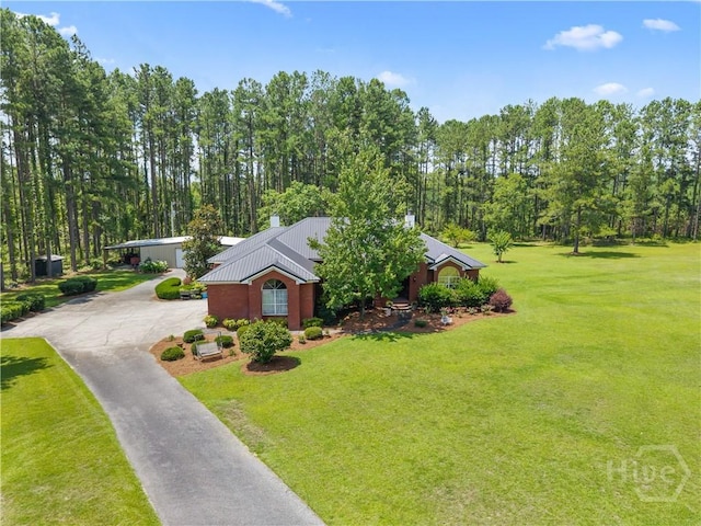 2055 Blankenbaker Rd, Statesboro, GA 30458 - view of front of house featuring concrete driveway, a front yard, a chimney, and a metal roof
