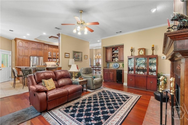2055 Blankenbaker Rd, Statesboro, GA 30458 - living area featuring beverage cooler, ceiling fan, crown molding, light wood-style flooring, and a fireplace
