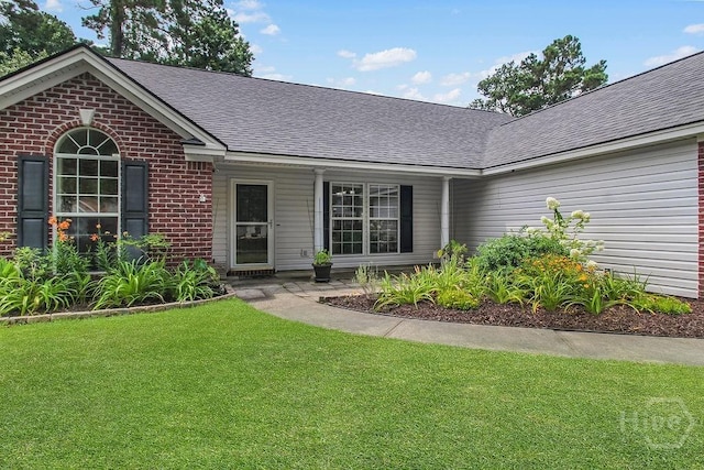 250 Laurel Hill Cir, Richmond Hill, GA 31324 - view of front of house with brick siding, a front lawn, and a shingled roof