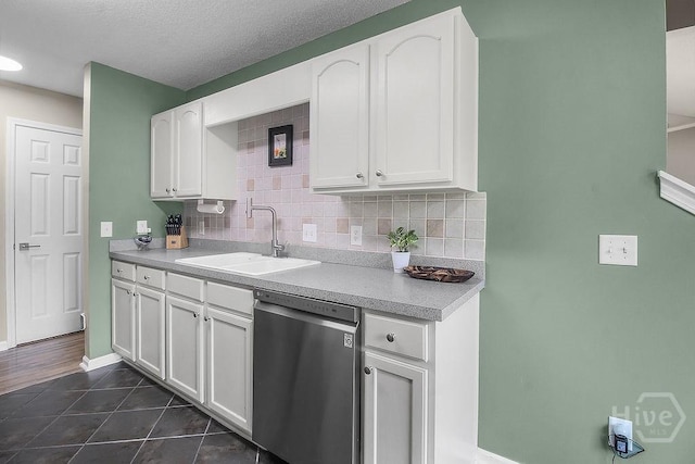 250 Laurel Hill Cir, Richmond Hill, GA 31324 - kitchen featuring stainless steel dishwasher, white cabinetry, dark tile patterned floors, tasteful backsplash, and light countertops