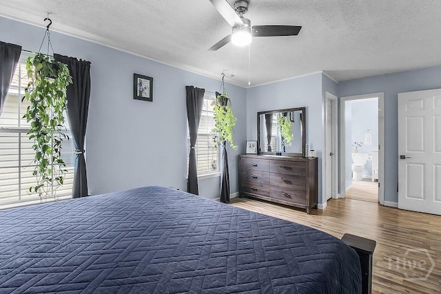 250 Laurel Hill Cir, Richmond Hill, GA 31324 - bedroom with a textured ceiling, wood finished floors, crown molding, connected bathroom, and ceiling fan