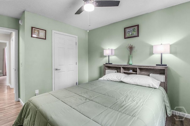250 Laurel Hill Cir, Richmond Hill, GA 31324 - bedroom with wood finished floors and a ceiling fan