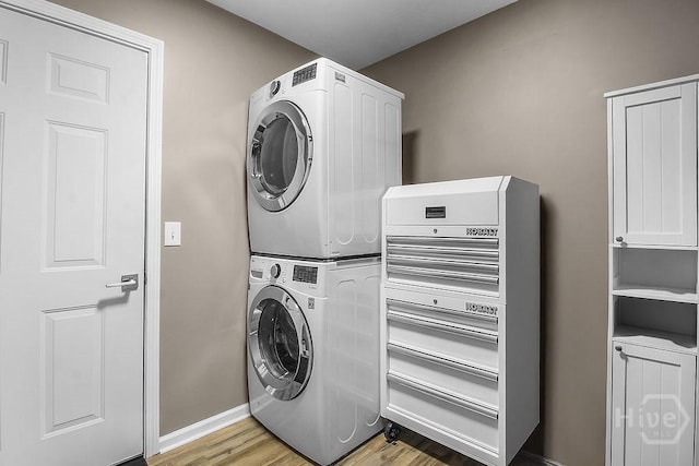 250 Laurel Hill Cir, Richmond Hill, GA 31324 - washroom with stacked washer / dryer and light wood-style flooring