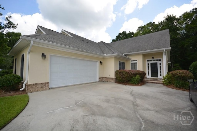 2 Jasmine Xing, Savannah, GA 31405 - single story home featuring brick siding, an attached garage, driveway, stucco siding, and a shingled roof