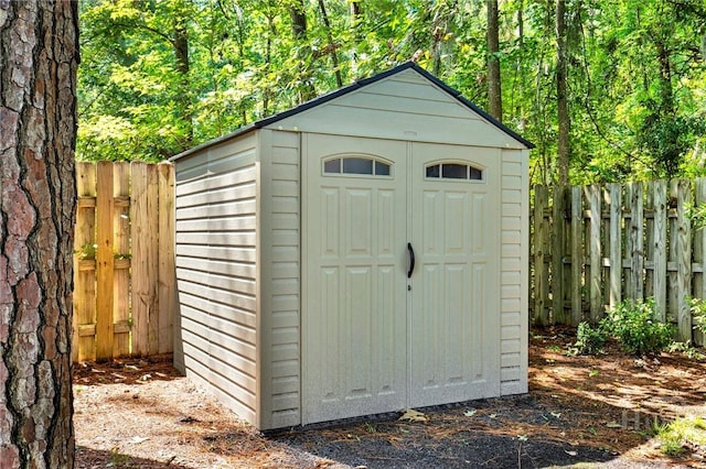 716 Greenwich Dr, Richmond Hill, GA 31324 - view of shed featuring a fenced backyard and a view of trees