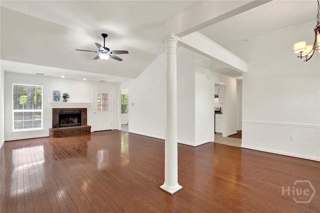 716 Greenwich Dr, Richmond Hill, GA 31324 - unfurnished living room featuring ceiling fan, hardwood / wood-style flooring, vaulted ceiling, a fireplace, and decorative columns