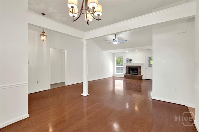 716 Greenwich Dr, Richmond Hill, GA 31324 - unfurnished living room featuring a chandelier, wood finished floors, a fireplace, a ceiling fan, and ornate columns