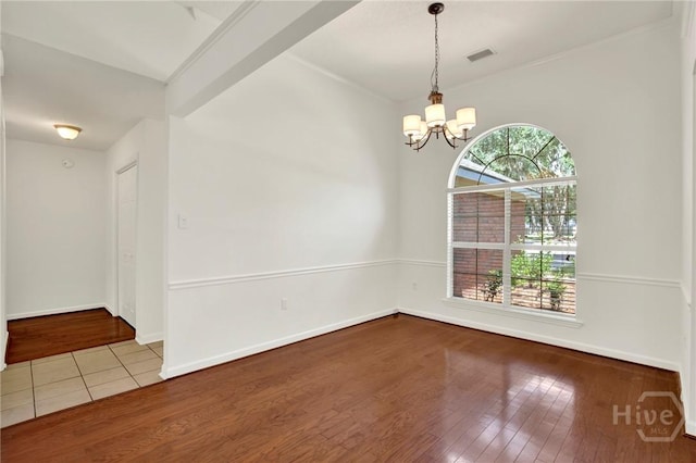 716 Greenwich Dr, Richmond Hill, GA 31324 - unfurnished room featuring wood-type flooring and a chandelier