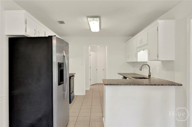 716 Greenwich Dr, Richmond Hill, GA 31324 - kitchen featuring stainless steel refrigerator with ice dispenser, light tile patterned flooring, white cabinets, and a peninsula