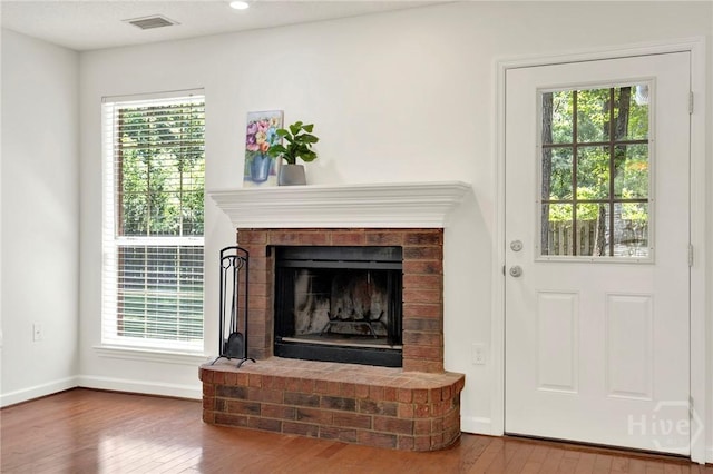 716 Greenwich Dr, Richmond Hill, GA 31324 - detailed view of wood finished floors, a brick fireplace, and recessed lighting