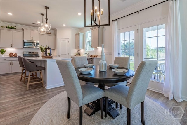 33 Spring Hill Dr, Richmond Hill, GA 31324 - dining area featuring crown molding, light wood-type flooring, recessed lighting, and a chandelier