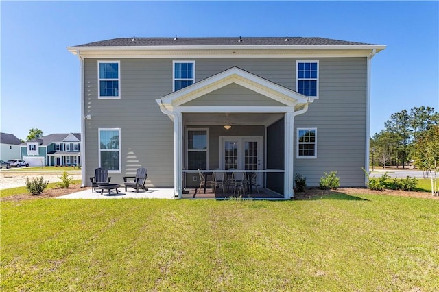 33 Spring Hill Dr, Richmond Hill, GA 31324 - rear view of property featuring a patio, a lawn, and a sunroom