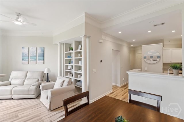 2536 Whitemarsh Way, Savannah, GA 31410 - living room with light wood finished floors, ceiling fan, ornamental molding, recessed lighting, and built in shelves