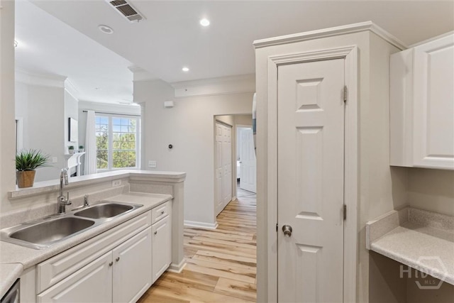 2536 Whitemarsh Way, Savannah, GA 31410 - kitchen featuring ornamental molding, white cabinetry, light countertops, light wood-style flooring, and recessed lighting