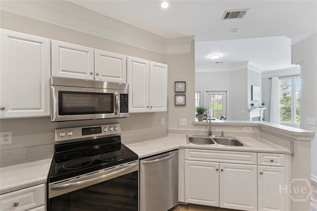 2536 Whitemarsh Way, Savannah, GA 31410 - kitchen with appliances with stainless steel finishes, light countertops, white cabinetry, crown molding, and recessed lighting
