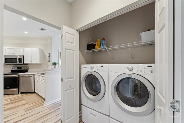 2536 Whitemarsh Way, Savannah, GA 31410 - laundry room with light wood-style flooring, washing machine and dryer, and recessed lighting