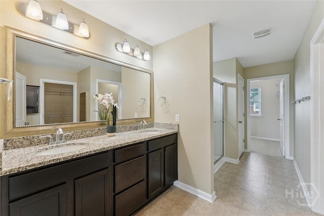 54 Winslow, Savannah, GA 31407 - bathroom featuring a walk in closet, double vanity, and a shower stall