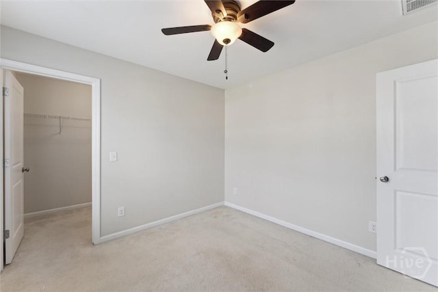 54 Winslow, Savannah, GA 31407 - unfurnished bedroom with a walk in closet, light carpet, and ceiling fan