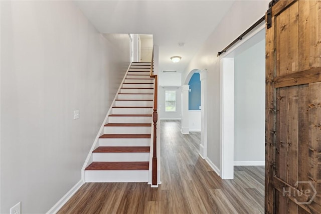 54 Winslow, Savannah, GA 31407 - staircase with arched walkways, wood finished floors, and a barn door