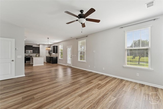 54 Winslow, Savannah, GA 31407 - unfurnished living room featuring light wood-type flooring, ceiling fan, recessed lighting, and a chandelier
