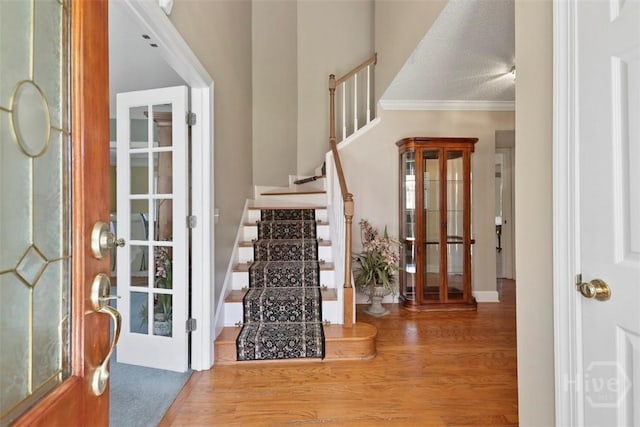114 Lakeview Ct, Savannah, GA 31406 - entrance foyer featuring wood finished floors, stairway, and crown molding