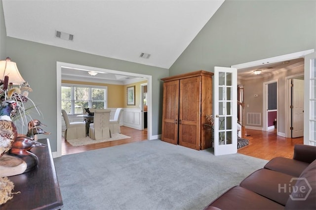 114 Lakeview Ct, Savannah, GA 31406 - carpeted living room with ornamental molding, french doors, high vaulted ceiling, and wood finished floors