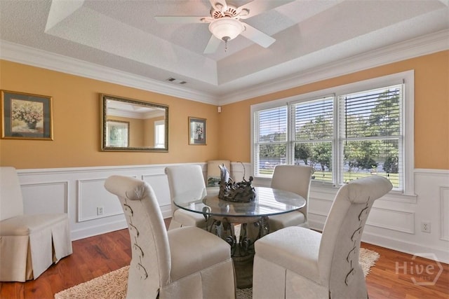 114 Lakeview Ct, Savannah, GA 31406 - dining space with a tray ceiling, plenty of natural light, crown molding, a ceiling fan, and wainscoting