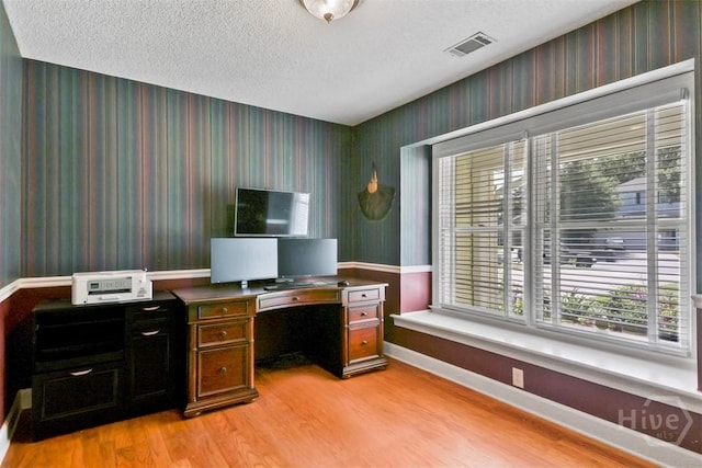 114 Lakeview Ct, Savannah, GA 31406 - office with wallpapered walls, light wood-type flooring, and a textured ceiling