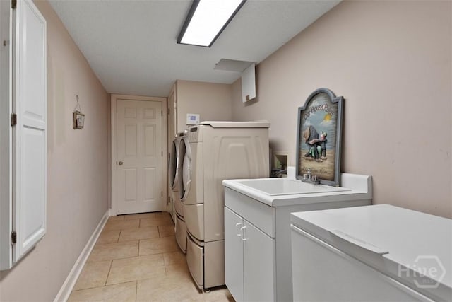 114 Lakeview Ct, Savannah, GA 31406 - laundry room featuring independent washer and dryer, light tile patterned floors, and cabinet space
