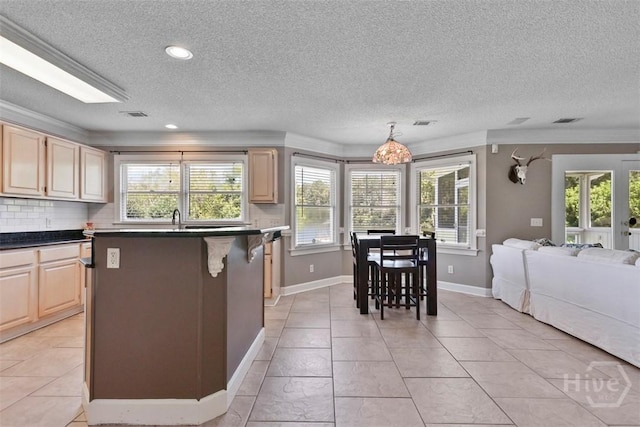 114 Lakeview Ct, Savannah, GA 31406 - kitchen with light brown cabinetry, open floor plan, dark countertops, healthy amount of natural light, and a textured ceiling