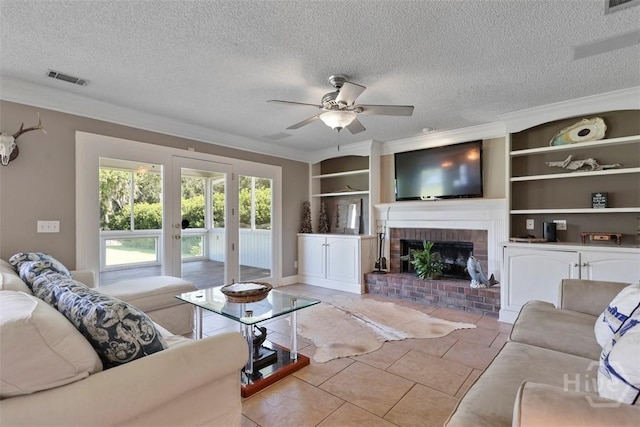 114 Lakeview Ct, Savannah, GA 31406 - living room with crown molding, a ceiling fan, built in features, a fireplace, and a textured ceiling
