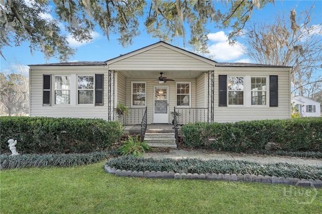 345 Magnolia St, Richmond Hill, GA 31324 - view of front of house with ceiling fan, a front lawn, and covered porch