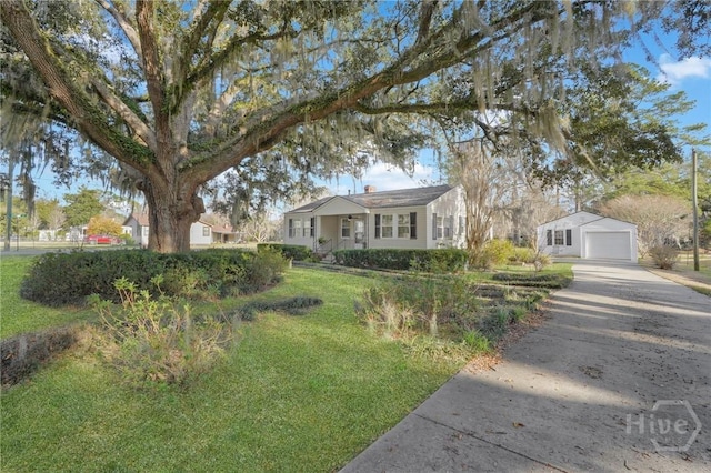 345 Magnolia St, Richmond Hill, GA 31324 - view of front of property with driveway, a front lawn, a detached garage, and an outdoor structure