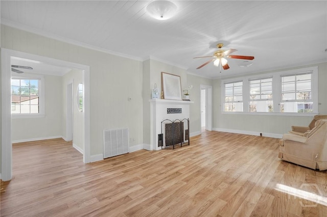 345 Magnolia St, Richmond Hill, GA 31324 - unfurnished living room with a ceiling fan, light wood-style floors, ornamental molding, and a fireplace