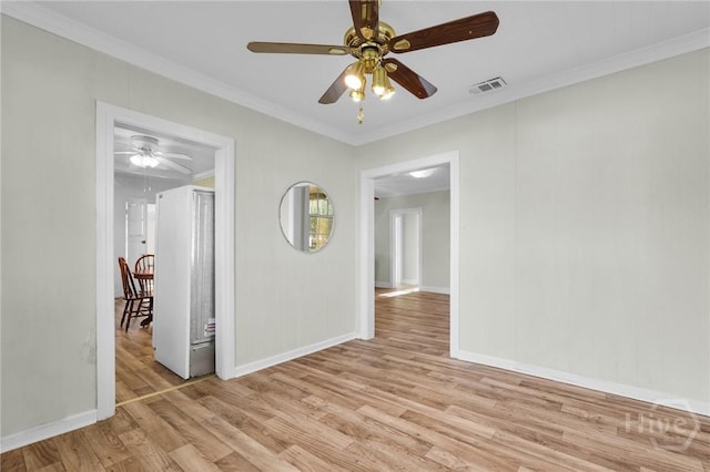 345 Magnolia St, Richmond Hill, GA 31324 - spare room with light wood-style floors, ceiling fan, and crown molding
