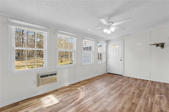 345 Magnolia St, Richmond Hill, GA 31324 - foyer featuring wood finished floors, a textured ceiling, ceiling fan, and an AC wall unit