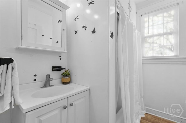 345 Magnolia St, Richmond Hill, GA 31324 - bathroom with vanity, a shower with shower curtain, and wood finished floors