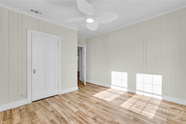 345 Magnolia St, Richmond Hill, GA 31324 - unfurnished bedroom with wood finished floors, crown molding, ceiling fan, and wooden walls