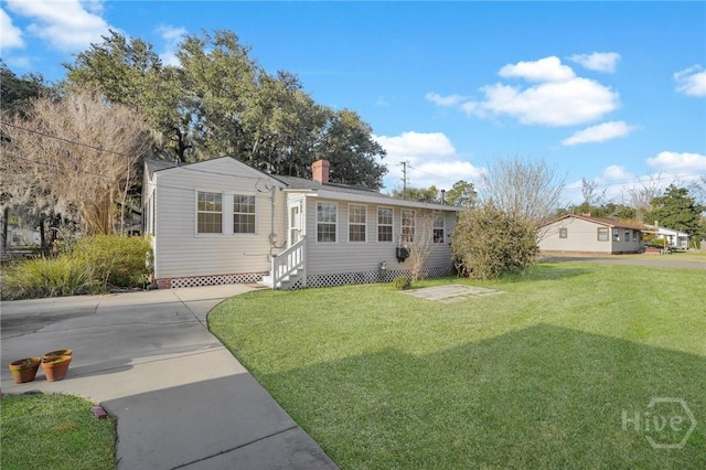 345 Magnolia St, Richmond Hill, GA 31324 - view of front facade featuring entry steps, a front yard, and a chimney