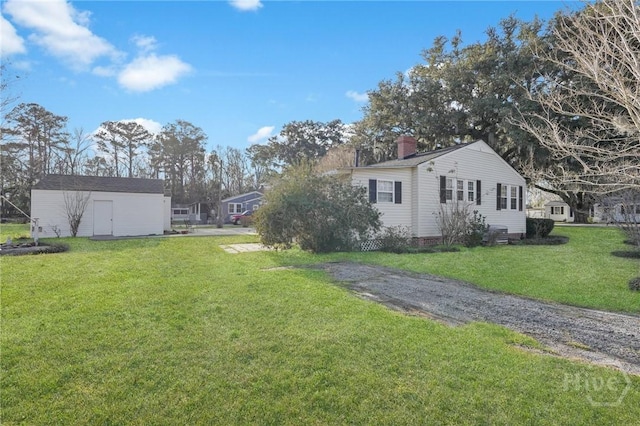 345 Magnolia St, Richmond Hill, GA 31324 - view of green lawn featuring a storage shed