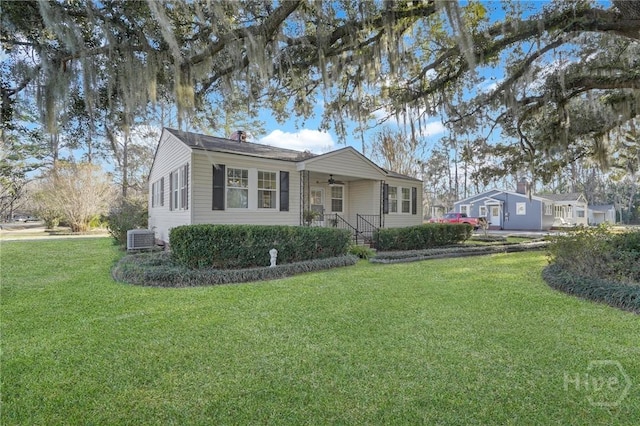 345 Magnolia St, Richmond Hill, GA 31324 - view of front of home with ceiling fan, a front yard, and a chimney