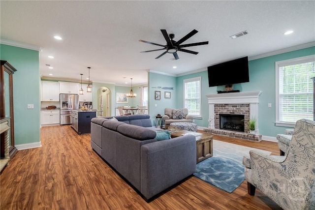 523 Goodman Dr, Midway, GA 31320 - living area featuring a fireplace, crown molding, wood finished floors, recessed lighting, and ceiling fan