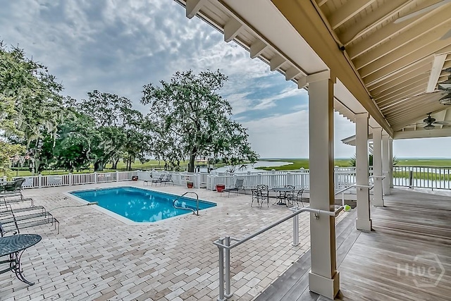 523 Goodman Dr, Midway, GA 31320 - community pool with ceiling fan, a water view, and a patio area