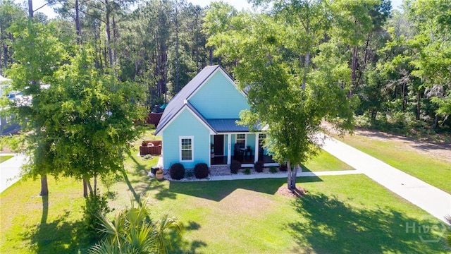 523 Goodman Dr, Midway, GA 31320 - rear view of house with driveway, a yard, a metal roof, and a porch