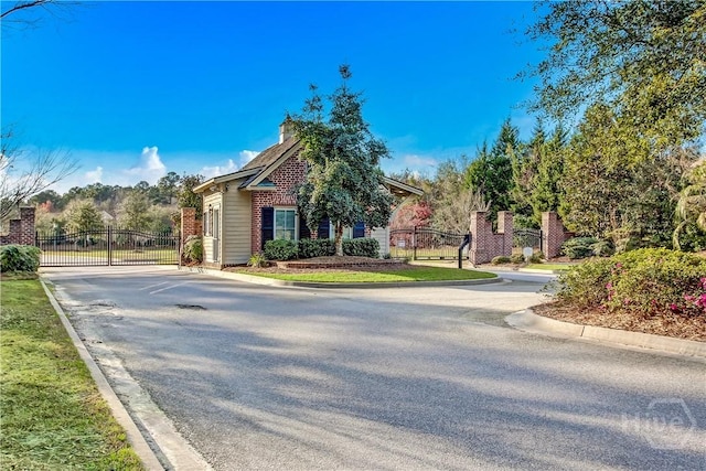 143 Regency Cir, Pooler, GA 31322 - view of asphalt street featuring a gate, curbs, and a gated entry