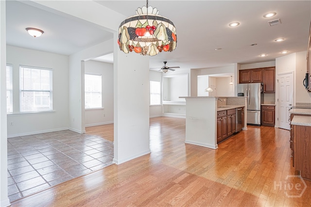 143 Regency Cir, Pooler, GA 31322 - kitchen with open floor plan, a ceiling fan, brown cabinets, appliances with stainless steel finishes, and recessed lighting