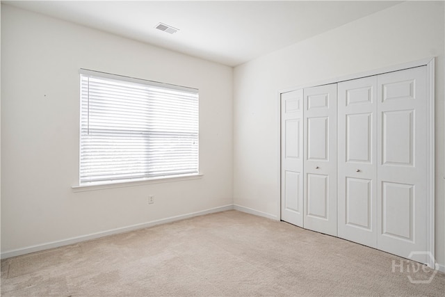 143 Regency Cir, Pooler, GA 31322 - unfurnished bedroom with carpet flooring, multiple windows, and a closet