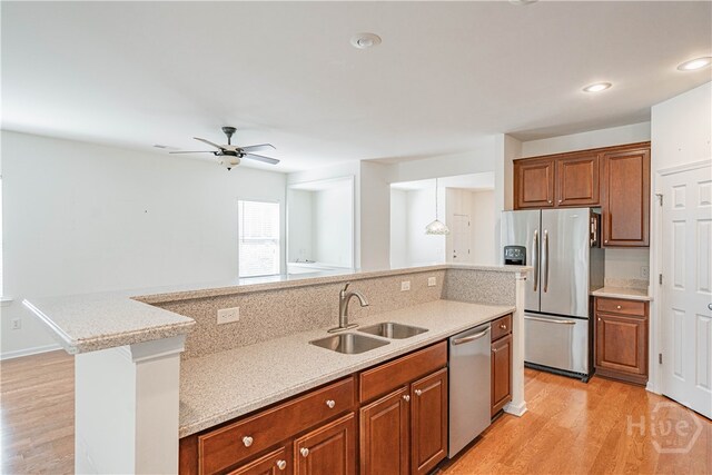 143 Regency Cir, Pooler, GA 31322 - kitchen featuring appliances with stainless steel finishes, light wood finished floors, brown cabinets, ceiling fan, and recessed lighting