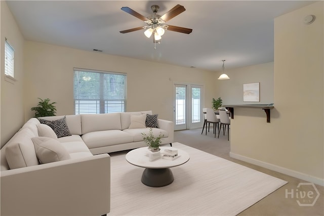 650 Summer Hill Way, Richmond Hill, GA 31324 - living area featuring healthy amount of natural light, a ceiling fan, and light colored carpet